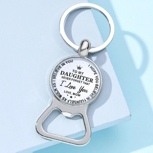 Detail of silver bottle opener keychain with inspirational message from mom to daughter