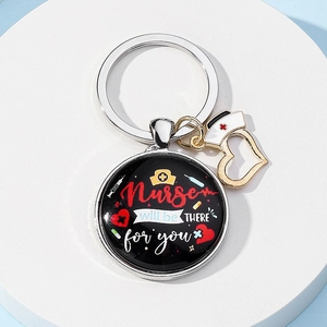 Detail showing 'Nurse will be THERE for you' pendant with heart and hat charms