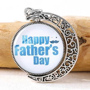 Close-up of vintage silver spinning moon keychain with Happy Father's Day engraving