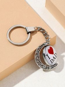 Detailed view of moon-shaped DAD keychain with vintage silver finish and glass dome