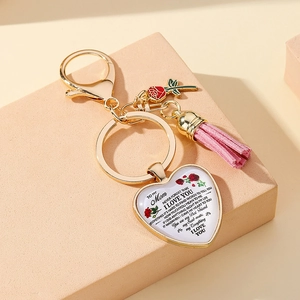 Detailed view of heart pendant keychain with pink tassel and To My Mom engraving