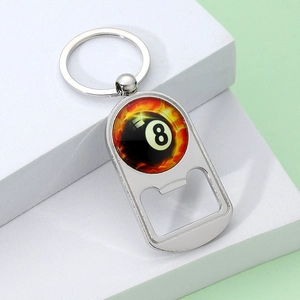 Polished metal 8-ball billiard bottle opener keychain on light green background