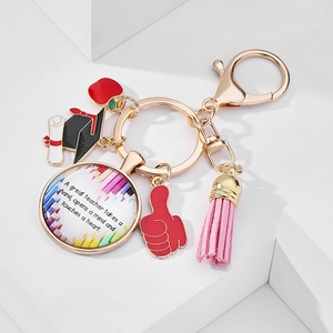Detail of teacher appreciation keychain with apple charm, tassel, and inspirational quote