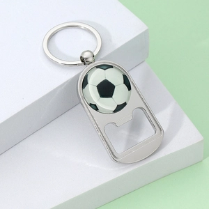 Close-up of a silver-tone metal soccer keychain with an integrated bottle opener feature