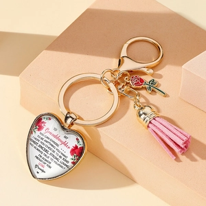 Detail of heart-shaped keychain with pink tassel and rose charm for Mother's Day gift