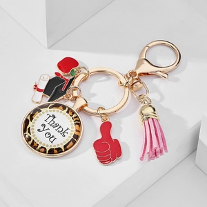 Detail of graduation keychain with leopard print charm and colorful enamel charms