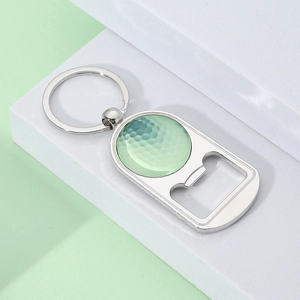 Macro detail of a silver metal golf ball bottle opener keychain on a display stand