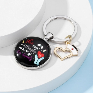 Detailed view of Nurse keychain with She works willingly with her hands text and charms