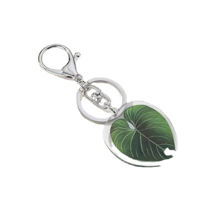 Leaf acrylic keychain pendant with green philodendron pattern on white background