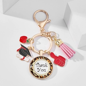 Close-up of teacher appreciation keychain with leopard heart charm and pink tassel