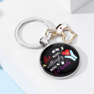Macro detail of nurse keychain with heart pendant on white geometric background