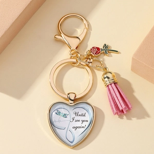 Detail of heart pendant keychain with red rose and pink tassel for Mother's Day
