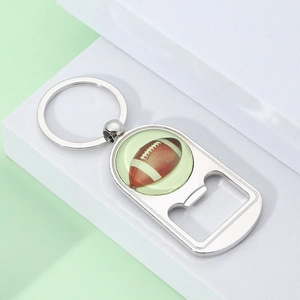 Detailed view of silver metal American football bottle opener keychain on a modern background