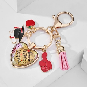 Detailed shot of teacher appreciation keychain with teach love inspire heart pendant