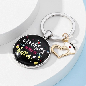 Close-up of nurse themed keychain with glass pendant and heart charm on display