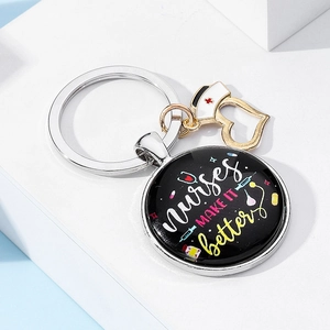 Detail of nurse gift keychain with enamel medical charms and motivational text on white background