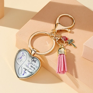 Detailed view of Mom heart glass pendant with pink leather tassel and red rose charm