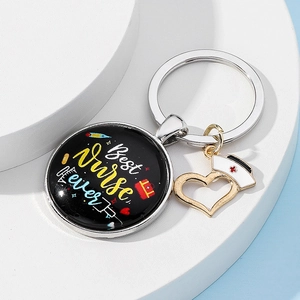 Detailed view of Best Nurse Ever keychain with a white nurse hat and heart shaped charms