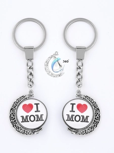 Detail showing 360-degree rotating silver moon keychain with I Love Mom engraving