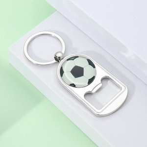Close-up of polished silver metal football keychain with integrated bottle opener