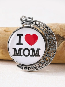 Detail of rotating crescent moon pendant with I Love MOM text on rustic wood