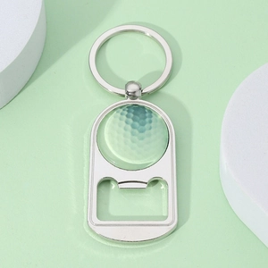 Detailed view of a green golf ball themed metal keychain bottle opener with silver finish