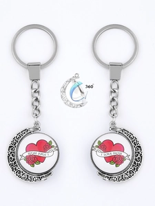 Detail of a rotating silver moon keychain with I LOVE MOM heart and rose design