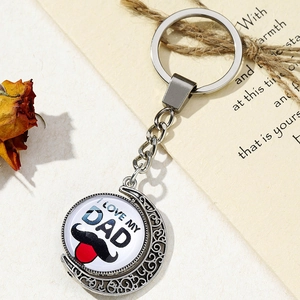 Detail view of rotating I LOVE MY DAD pendant on a silver moon keychain gift set