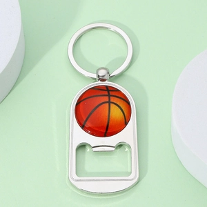 Detail of silver metal basketball keychain with integrated bottle opener and glossy finish