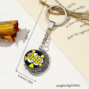 Close-up of rotating moon keychain featuring Father's Day Dad graphic on vintage paper