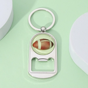 Close-up of a silver metal American football bottle opener keychain with glossy finish