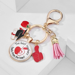 Detail of teacher gift keychain with glass cabochon, red apple charm and pink tassel