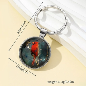 Silver keychain with a red cardinal bird pendant shown on a white display stand