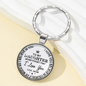 Macro shot of a silver metal keychain with an emotional message for a daughter from a mother