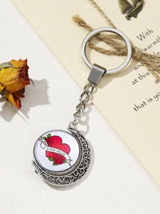 Close-up of heart and rose pendant on silver moon keychain for Mother's Day gift