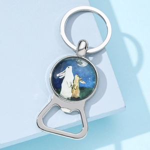 Detail of silver bottle opener keychain with moon rabbit artistic glass gem illustration