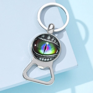 Close-up of a silver dragon eye glass cabochon metal keychain with bottle opener function