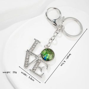 Silver metal LOVE keychain with sparkling crystals and colorful peacock glass pendant