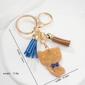 Charming amber acrylic cat keychain with blue bowknot and tassels for cute gift