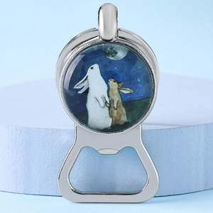 Polished silver bottle opener keychain featuring a cartoon rabbit gazing at the moon