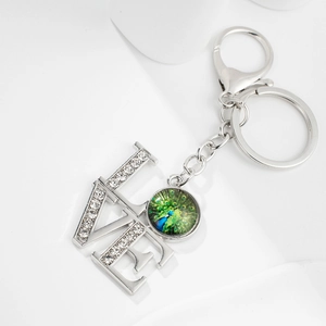 Silver LOVE keychain with peacock pattern glass cabochon and crystal rhinestones