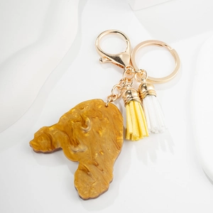 Porte-clés caniche en acrylique ambré avec glands bicolores et fermoir doré