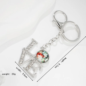 Silver flower pendant keychain with sparkling rhinestones and LOVE lettering design