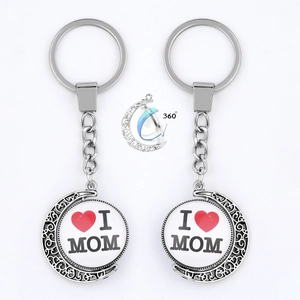 Rotating silver crescent moon keychain with I Love Mom pendant on white background