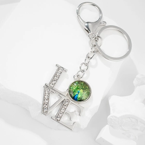 Silver peacock gemstone keychain with LOVE charm and sparkling rhinestones for gifts