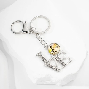 Detail of silver LOVE keychain with rhinestones and vintage cat tennis glass pendant