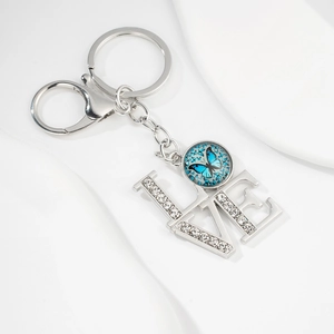 Detail of silver LOVE keychain with blue butterfly glass gem and sparkling rhinestones