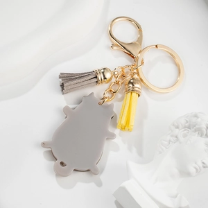 Cute cartoon cat keychain with golden metal ring and stylish dual-color tassels for bags