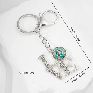 Detailed view of Mandala LOVE keychain with dimensions 9.7cm length and rhinestones