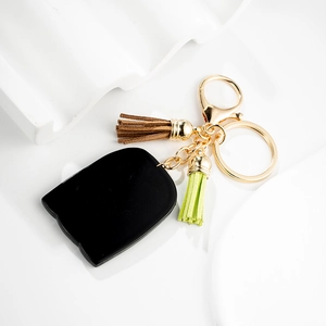 Creative black cat silhouette keychain with brown and green tassels and golden hardware